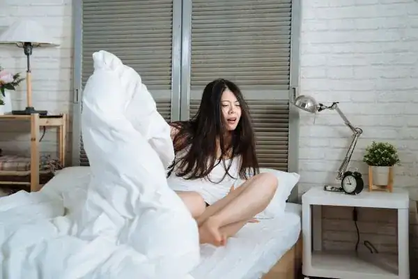 Image of woman getting up because of nighttime leaks Cardiff